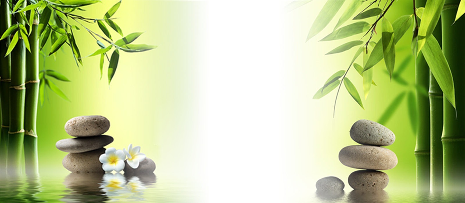 Bamboo and stacked stones over still water